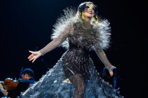 Björk Instagram - thank you @coachella for a wonderful evening !! 
 
conductor @bjarnifrimann 
orchestra : hollywood string ensemble 
björk dresses @noirkeininomiya
headpiece @james.t.merry
latex slip dresses @xvenusprototypex
bodysuit @solangel 
hairpiece @tomikono_wig
makeup @isshehungry
bjarni frimann wearing @jonnycotastudio
styling @eddagud
mask design & 3D sculpt @james.t.merry
mask production @secca_kanazawa
3D printing support by DMM.make
mask technical direction @suganokaoru
producer : reiko kunieda
photos @santiagraphy