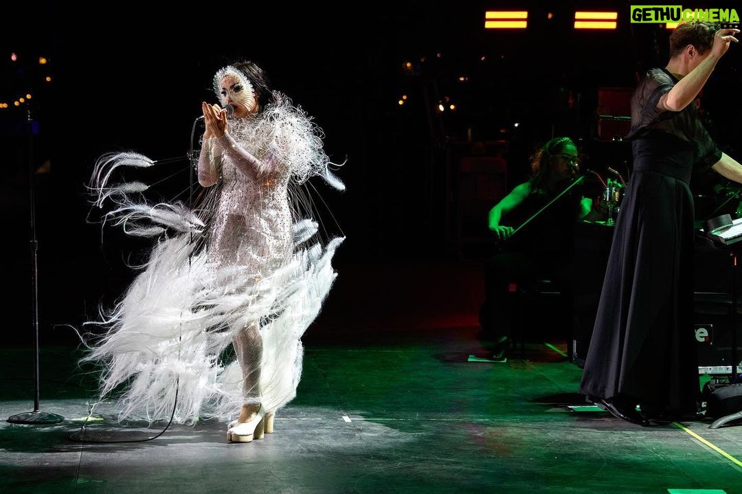 Björk Instagram - @coachella thank you for a magical evening !! conductor @bjarnifrimann orchestra : hollywood string ensemble björk dress @noirkeininomiya headpiece @james.t.merry bodysuit @solangel led sound reacting dress @claradaguin silver skirt @weishengparis makeup @isshehungry bjarni frímann top @maisonvalentino skirt @weishengparis styling @eddagud photos @santiagraphy drone photos @charles.reagan mask design & 3D sculpt @james.t.merry mask production @secca_kanazawa 3D printing support by DMM.make mask technical direction @suganokaoru producer : reiko kunieda drone light performance by @studio.drift @dronestories.show @twofiftyk @novaskystories björk creative direction : björk , @james.t.merry Coachella