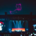 Björk Instagram – @coachella thank you for a magical evening !! 

conductor @bjarnifrimann 
orchestra : hollywood string ensemble 
björk dress @noirkeininomiya 
headpiece @james.t.merry 
bodysuit @solangel 
led sound reacting dress @claradaguin 
silver skirt @weishengparis
makeup @isshehungry 
bjarni frímann top @maisonvalentino 
skirt @weishengparis 
styling @eddagud 
photos @santiagraphy 
drone photos @charles.reagan 
mask design & 3D sculpt @james.t.merry 
mask production @secca_kanazawa 
3D printing support by DMM.make
mask technical direction @suganokaoru 
producer : reiko kunieda 

drone light performance by 
@studio.drift 
@dronestories.show 
@twofiftyk 
@novaskystories 
björk creative direction :
björk , @james.t.merry Coachella