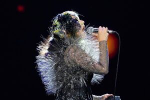 Björk Instagram - thank you @coachella for a wonderful evening !! 
 
conductor @bjarnifrimann 
orchestra : hollywood string ensemble 
björk dresses @noirkeininomiya
headpiece @james.t.merry
latex slip dresses @xvenusprototypex
bodysuit @solangel 
hairpiece @tomikono_wig
makeup @isshehungry
bjarni frimann wearing @jonnycotastudio
styling @eddagud
mask design & 3D sculpt @james.t.merry
mask production @secca_kanazawa
3D printing support by DMM.make
mask technical direction @suganokaoru
producer : reiko kunieda
photos @santiagraphy