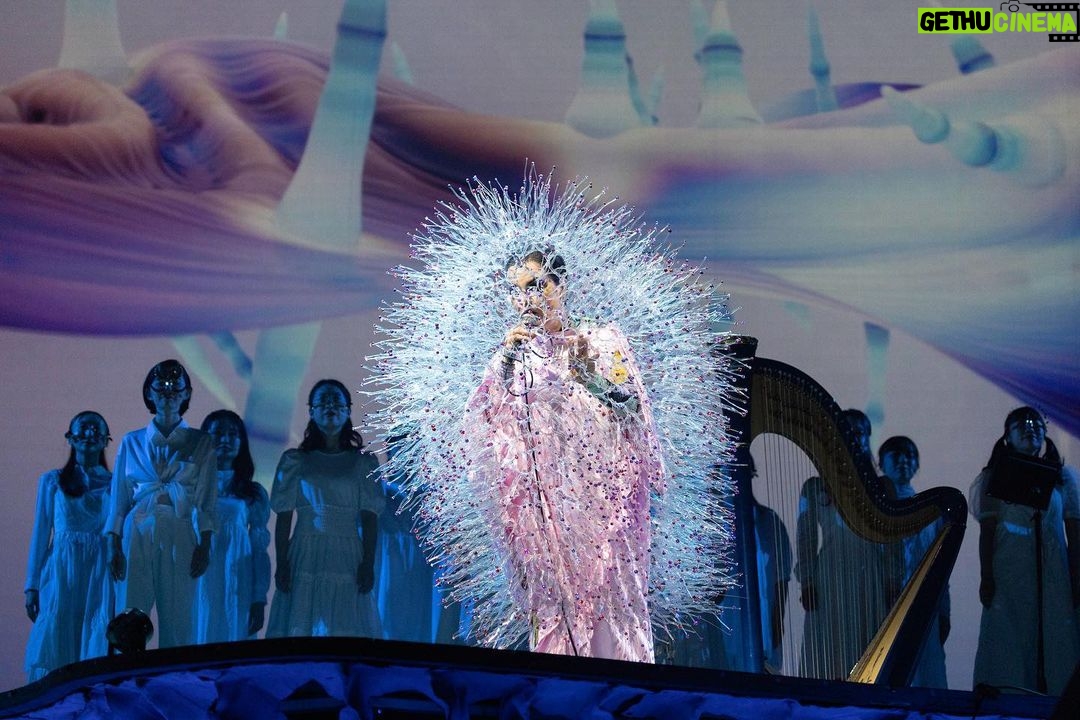 Björk Instagram - thank you tokyo for a great evening and thank you @kasimyn for joining us ! musicians @viibraflutes , @bergurth , @manudelagomusic , @katiebuckleyharpist , @kasimyn choir : @utabito_zanmai_samady photos @santiagraphy björk outfits @noirkeininomiya printed bodysuit @thorastefansdottir kas outfit @tomokoizumi all band outfits @balmain all headpieces @james.t.merry all hairpieces @tomikono_wig makeup @isshehungry styling @eddagud