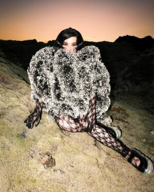 Björk Instagram - i am so honoured to be featured in purple magazine ... it is kinda nuts it is my first time as i recently tidied up my garage and found boxes of old issues ... and strangely enough for some education gave them all to an up and coming photographer in iceland in the middle of covid . the world arranges itself in mysterious and miraculous ways and now few years later that same photographer @vidarlogi is capturing me for the cover in iceland ́s red lava hills .

i would like to thank especially my interviewer @ubi.sunt for initiating this , picking a lush location and an extremely fertile dialogue that is still crocheting it ́s way around my brain ... my inner neurology gently vibrating in the aftershock : i bow , i bow . thanks to @james.t.merry , @eddagud , @joanlbert , @sverrirps , @sunnabjorkmakeup , @steinunnhairstylist for all the help on a sublime day in nature . and to @ozpurple for fighting the integrity fight through decades of keeping niche media relevant and evolving in changing times

@purplefashionmagazine 
outfits @noirkeininomiya 
shoes @grounds.official