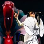 Björk Instagram - thanks for tonight nantes! musicians : @viibraflutes @bergurth @manudelagomusic @katiebuckleyharpist bjork dress @delcoreofficial @danieldelcore latex bodysuit @xvenusprototypex shoes @maisonmargiela floral dress @marni headpieces @james.t.merry musicians outfits @balmain hair @johnvialhair musicians hair @tomikono_wig makeup @isshehungry styling @eddagud photos @santiagraphy Nantes, France