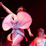 Björk Instagram - thanks for tonight nantes! musicians : @viibraflutes @bergurth @manudelagomusic @katiebuckleyharpist bjork dress @delcoreofficial @danieldelcore latex bodysuit @xvenusprototypex shoes @maisonmargiela floral dress @marni headpieces @james.t.merry musicians outfits @balmain hair @johnvialhair musicians hair @tomikono_wig makeup @isshehungry styling @eddagud photos @santiagraphy Nantes, France