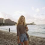 Emily Bett Rickards Instagram - Growing up our relatives were always on the other end of a plane ride. My parents, brother and I were west coasters but my memories of summer are all east coast. Thick air, mosquitos the size of quarters, bagged milk… My cousins backyard where the meals were dominated by corn on the cob and whatever nuclear colour of powdered mixed drink was popular that year. The next (and every) morning Dad would convince me run with him to the house he grew up in just so we could cannonball in the ancient pool. I miss this the most. Not the relief from humidity or the smell of fabric softener but I miss something I don’t think I ever saw: my Grandmother seeing her favourite boy barrel through the front door, out the back one and into the water. Grandma stayed a Polish mystery to me. A stout woman with a yellow car that spoke German when you turned it on, a sun room full of Eastern European dolls and a patio frequently visited by the animals in the area waiting to feed on peanuts out of her pockets. She was known for her stern nature, for illegally slipping me cash, and her killer apple pie. She was hard to get to know but I loved her. I spent eras in her house but Grandma only made it out west once to visit me. I remember her in our kitchen scolding me for playing with a raw egg. I remember her telling me she hated flying and I remember feeling brave next to her when she got scared stiff by the thunderstorm that struck our house one night. As a child, I felt so “other” to her. Strangers if not for family. I didn’t understand why she wouldn’t fly to see me more? Why with what few planes she did take she did so to visit Hawaii? Walking the beaches as an adult myself I think that her need for a different form of peace was stronger than her fear of flying. In my early teens she fell sick. Right before she passed she finally let us hear the stories from the war that lived deep in her blood. I understood her then. We spread her ashes here so she could rest forever. I have her stubbornness, her hands and her weird pinky toe that I take everywhere with me, especially when I am fortunate enough to be a guest on the sands of Hawaii. Mahalo.
