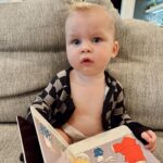 Heather Rae El Moussa Instagram - Friday mood: 😜 I blinked and he’s already sitting up all by himself, smiling for the camera giggling non-stop, and he has two teeth that came in & 2 more piercing through 🥹 Swipe for cuteness 🤍