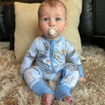 Heather Rae El Moussa Instagram - Friday mood: 😜 I blinked and he’s already sitting up all by himself, smiling for the camera giggling non-stop, and he has two teeth that came in & 2 more piercing through 🥹 Swipe for cuteness 🤍