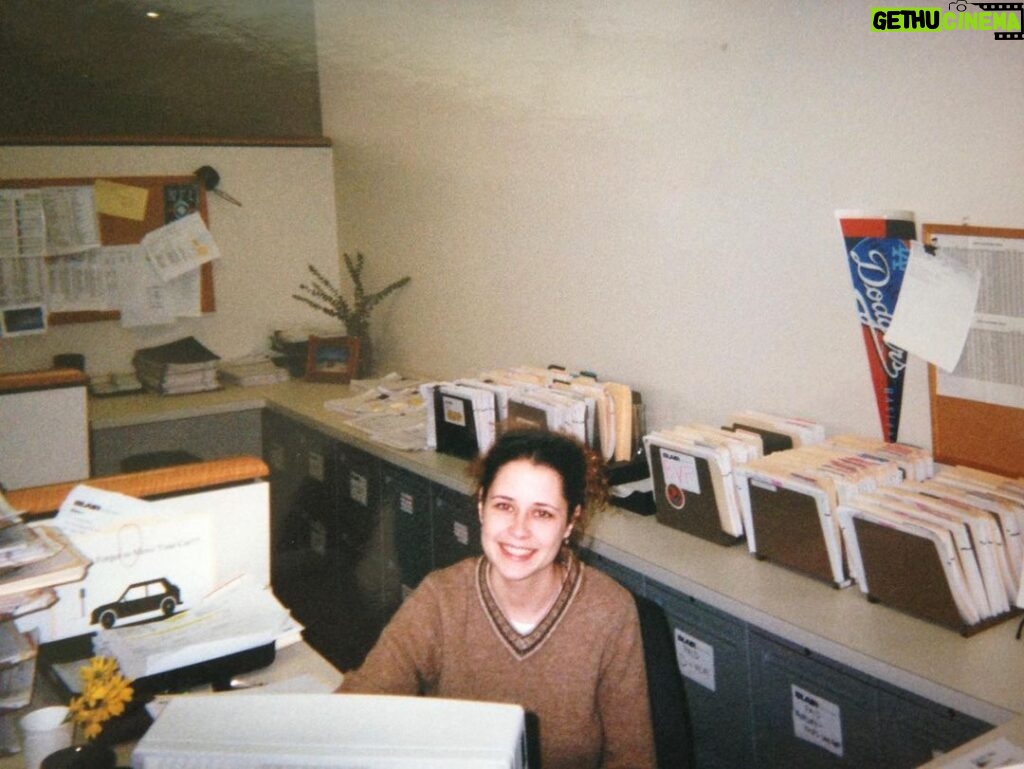 Jenna Fischer Instagram - #OneDayMay Today’s Prompt…Throwback version of me… Here I am working one of my many admin jobs in my years before landing on The Office. Please admire the elaborate filing system behind me. I was very proud of that. I liked this job. I worked as an assistant to a media buyer. It was mostly data entry (and filing). The Dodgers pennant belonged to the assistant before me. The daisies are mine!