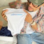 Kelly McCreary Instagram - Baby’s first onesie! The absolute best moment of all was sharing the news with @petechatmon. And how cute are these tiny things!! A heartfelt thanks again to @Clearblue for the affirmation and confirmation along our journey to starting a family! #ClearbluePartner, #ClearblueConfirmed