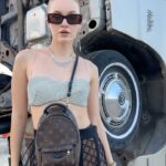Polina Pushkareva Instagram – Conclusions on Coachella 2023: the guide on how to survive

Coachella is a challenge. You’re trying to chill and enjoy the atmosphere, music, dating, but it’s very hard to be in the desert.

Wanna share my thoughts after the fest and what I will do next year.

1.Wear only gathered hairstyles and fix them well with hairspray. The wind is fuckingly strong, so the loose hair quickly turns into a nest.

2. Always carry a lipstick with you to quickly fix your makeup. If you can do without any lipstick, it’s even better. Plus, dust sticks on the lipstick which is quite unpleasant.

3. Wear cool and not super comfortable outfits for photo shoots in the desert. And it’s better to go to the festival in comfortable clothes, in which you can spend the whole night.

4. The face mask is a must-have. Be sure to take a backpack with you (not just a beautiful handbag) and put into it antihistamines, medicines for stomach and any other pills that you may need. Anything can happen in the desert, and the medical center is not always nearby.

5. Live alone and meet friends at the festival. That’s perfect. You can wake up and fall asleep whenever you want, do whatever you want and not adapt to other people’s plans.

6. Come to the festival by 7 p.m. Unless, of course, someone you love performs during the day. After 5 hours there you get so tired that you don’t enjoy it anymore. And the top artists start performing in the evening.

7. Take a tripod. I took all the photos in this trip myself. I just put the camera and posed as much as I wanted. If content is your priority, take a tripod, set aside one hour and calmly shoot yourself in different locations.

Btw, which outfit do you like most of all? Coachella, California