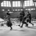Rachel Zegler Instagram - day 1 of shooting the hunger games: the ballad of songbirds and snakes — this scene was entitled “the bloodbath”. here i am accompanied by dave thompson, our incredible a-camera operator. for every step i ran, dave was always running just as fast, just a few feet behind. 🩷🕊️🐍 in theaters friday 🐍🕊️🩷 📸: @murrayclose Wrocław
