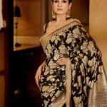 Raveena Tandon Instagram - Who better than Raveena Tandon (@officialraveenatandon) to celebrate the timeless allure of handwoven sarees! Someone who sparked the biggest of fashion trends and gave Bollywood some of the most iconic fashion moments, the actor harbours a special love for the six yards of silk. The beauty looks mesmerising in a black weave paired with a pair of statement earrings. The unconventional colour is a sure shot headturner in a sea of reds and maroons. Her subtle makeup: a feather light base, nude lipstick drenched in gloss and a touch of kohl on the eyes complements the look. Follow Showstoppers for more inspiration to make a style statement this wedding season. Concept & styling: @sharaashraf Photos: @amitkhannaphotography Production: @shweta__sunny & @kayanaaaaat Makeup and hair: @kin_vanity Location: @itcmaratha Outfit: Saree by @meerabypoornimasharma Jewellery: @sahai_ambar_pariddi #raveenatandon #raveenatandonfans #weddingspecial #weddingseason #weddingstyle #weddingoutfit #weddingoutfits #saree #sareelover #sareelove #varanasi @raveenatandonfanpage @raveenatandonbiggestfan @raveenatandon_trueadmirer @raveenatandonfan_