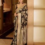 Raveena Tandon Instagram - Who better than Raveena Tandon (@officialraveenatandon) to celebrate the timeless allure of handwoven sarees! Someone who sparked the biggest of fashion trends and gave Bollywood some of the most iconic fashion moments, the actor harbours a special love for the six yards of silk. The beauty looks mesmerising in a black weave paired with a pair of statement earrings. The unconventional colour is a sure shot headturner in a sea of reds and maroons. Her subtle makeup: a feather light base, nude lipstick drenched in gloss and a touch of kohl on the eyes complements the look. Follow Showstoppers for more inspiration to make a style statement this wedding season. Concept & styling: @sharaashraf Photos: @amitkhannaphotography Production: @shweta__sunny & @kayanaaaaat Makeup and hair: @kin_vanity Location: @itcmaratha Outfit: Saree by @meerabypoornimasharma Jewellery: @sahai_ambar_pariddi #raveenatandon #raveenatandonfans #weddingspecial #weddingseason #weddingstyle #weddingoutfit #weddingoutfits #saree #sareelover #sareelove #varanasi @raveenatandonfanpage @raveenatandonbiggestfan @raveenatandon_trueadmirer @raveenatandonfan_