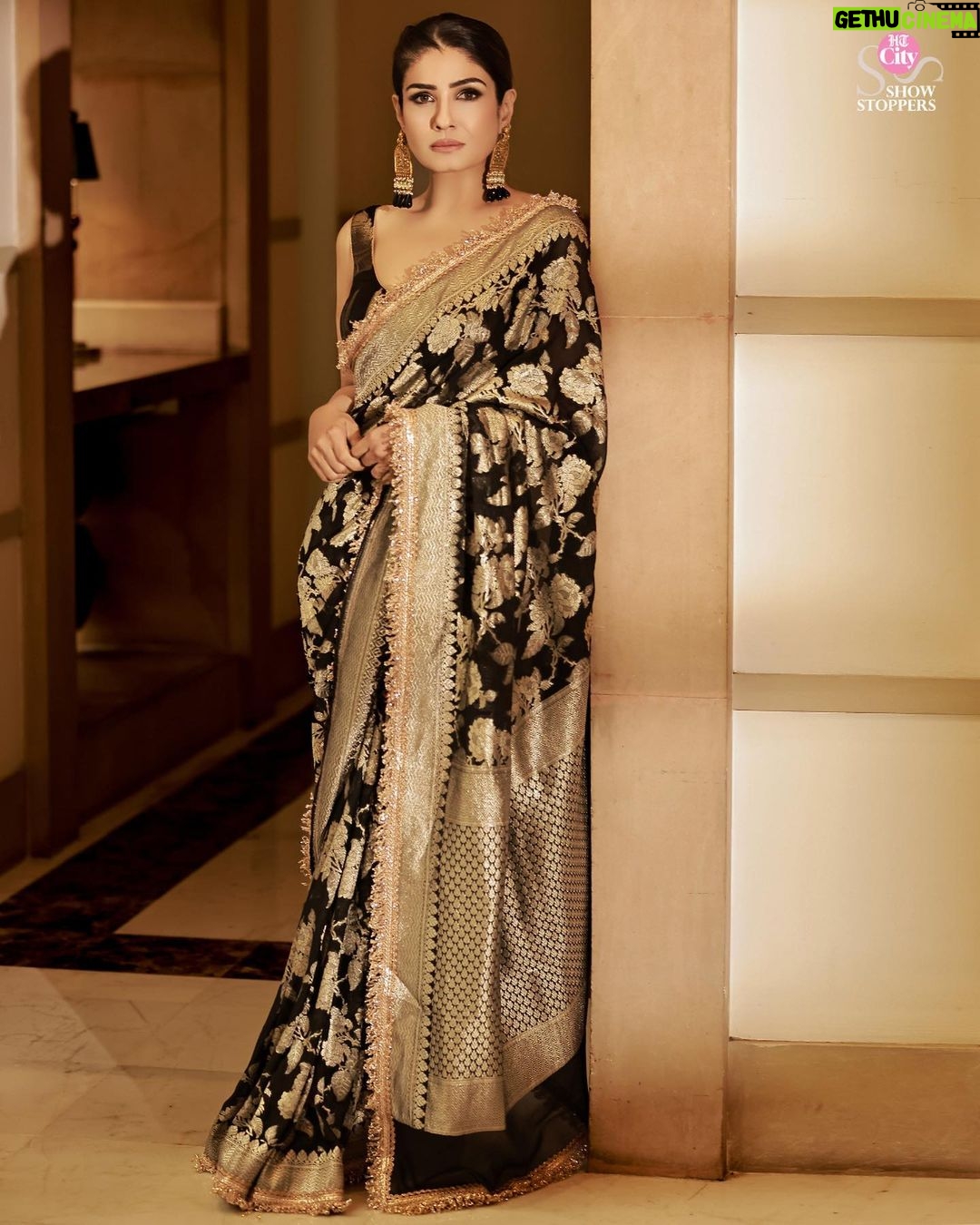 Raveena Tandon Instagram - Who better than Raveena Tandon (@officialraveenatandon) to celebrate the timeless allure of handwoven sarees! Someone who sparked the biggest of fashion trends and gave Bollywood some of the most iconic fashion moments, the actor harbours a special love for the six yards of silk. The beauty looks mesmerising in a black weave paired with a pair of statement earrings. The unconventional colour is a sure shot headturner in a sea of reds and maroons. Her subtle makeup: a feather light base, nude lipstick drenched in gloss and a touch of kohl on the eyes complements the look. Follow Showstoppers for more inspiration to make a style statement this wedding season. Concept & styling: @sharaashraf Photos: @amitkhannaphotography Production: @shweta__sunny & @kayanaaaaat Makeup and hair: @kin_vanity Location: @itcmaratha Outfit: Saree by @meerabypoornimasharma Jewellery: @sahai_ambar_pariddi #raveenatandon #raveenatandonfans #weddingspecial #weddingseason #weddingstyle #weddingoutfit #weddingoutfits #saree #sareelover #sareelove #varanasi @raveenatandonfanpage @raveenatandonbiggestfan @raveenatandon_trueadmirer @raveenatandonfan_
