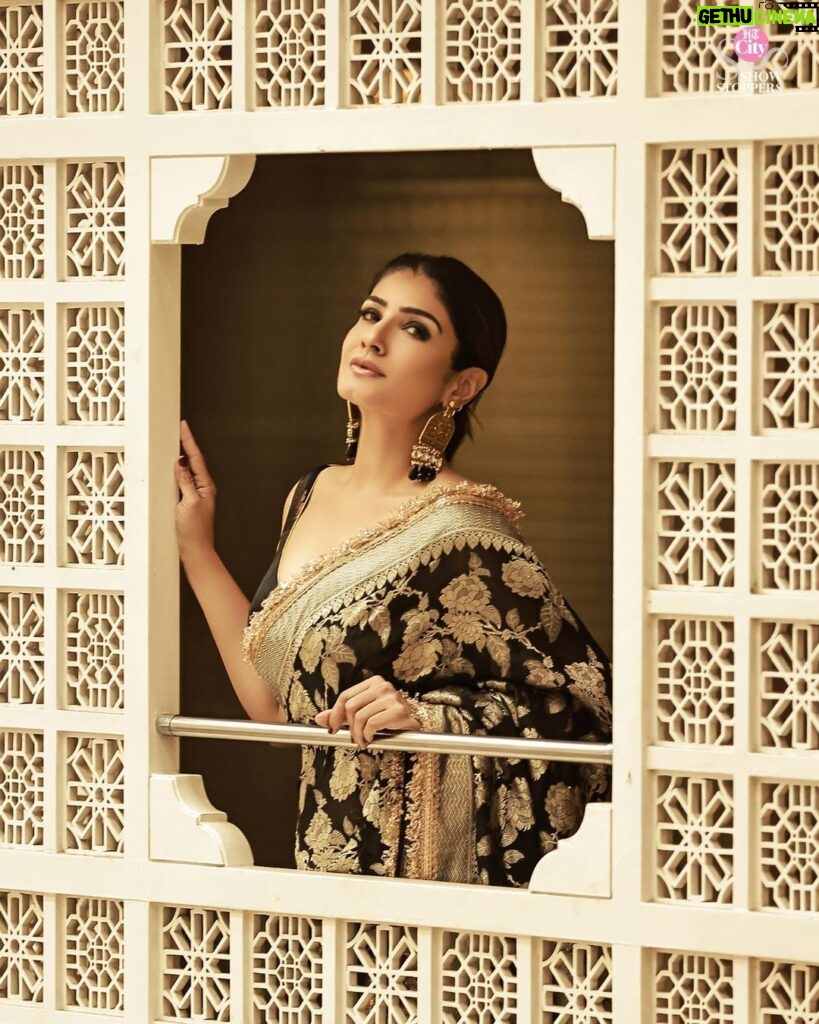 Raveena Tandon Instagram - Who better than Raveena Tandon (@officialraveenatandon) to celebrate the timeless allure of handwoven sarees! Someone who sparked the biggest of fashion trends and gave Bollywood some of the most iconic fashion moments, the actor harbours a special love for the six yards of silk. The beauty looks mesmerising in a black weave paired with a pair of statement earrings. The unconventional colour is a sure shot headturner in a sea of reds and maroons. Her subtle makeup: a feather light base, nude lipstick drenched in gloss and a touch of kohl on the eyes complements the look. Follow Showstoppers for more inspiration to make a style statement this wedding season. Concept & styling: @sharaashraf Photos: @amitkhannaphotography Production: @shweta__sunny & @kayanaaaaat Makeup and hair: @kin_vanity Location: @itcmaratha Outfit: Saree by @meerabypoornimasharma Jewellery: @sahai_ambar_pariddi #raveenatandon #raveenatandonfans #weddingspecial #weddingseason #weddingstyle #weddingoutfit #weddingoutfits #saree #sareelover #sareelove #varanasi @raveenatandonfanpage @raveenatandonbiggestfan @raveenatandon_trueadmirer @raveenatandonfan_