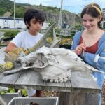 Milla Jovovich Instagram – We’re finally in Newfoundland for the last leg of @everanderson’s new movie #peterpanandwendy! We spent the day walking around the gorgeous town and had lunch at the historic @mallardcottage which was so delicious. They even have their own garden in the backyard and in the last pic you can see the way they roast meat, slow and low on hot coals made of wood from the area. Ever and her co-star @alexandermolonyofficial who plays Peter Pan had a great time finding old bones scattered around and trying to guess what each plant was growing in the garden. It’s a seaside town of charming, old houses painted in brilliant colors, sweet and friendly people and even cool vintage clothing stores. In the evening we sit downstairs at our hotel with the rest of the cast and parents playing Empire for hours! I feel so lucky to be experiencing this with my amazing kiddo! #peterpanandwendy #disney #newfoundland