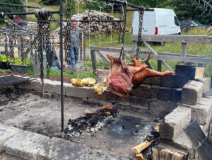 Milla Jovovich Instagram - We’re finally in Newfoundland for the last leg of @everanderson’s new movie #peterpanandwendy! We spent the day walking around the gorgeous town and had lunch at the historic @mallardcottage which was so delicious. They even have their own garden in the backyard and in the last pic you can see the way they roast meat, slow and low on hot coals made of wood from the area. Ever and her co-star @alexandermolonyofficial who plays Peter Pan had a great time finding old bones scattered around and trying to guess what each plant was growing in the garden. It’s a seaside town of charming, old houses painted in brilliant colors, sweet and friendly people and even cool vintage clothing stores. In the evening we sit downstairs at our hotel with the rest of the cast and parents playing Empire for hours! I feel so lucky to be experiencing this with my amazing kiddo! #peterpanandwendy #disney #newfoundland