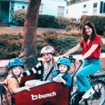 Caterina Scorsone Instagram - Have you been to Holland? One of the rad things about Holland is watching everyone whip around on bikes along the canals. The parents have bicycles with cargo cabs for the kids. Everybody gets to ride. 
October is here, which means it is Down Syndrome Awareness month! Last month @bunchbikes launched the Family Superhero program in an effort to make their awesome bikes more accessible, physically and financially, to more people. 
This bike is roomy, safe, and easy to ride. (And it doesn’t hurt to get a little electric boost when transporting a band of tiny humans around.) My littles and I love our Bunch Bike and we hope you will too! 

Beware! Do not let your toddler bring a random garden gnome with them on the ride. They WILL throw it over the side and the gnome will meet a gruesome demise. RIP Gnome. (It should also be noted that i ALWAYS wear a helmet…except when taking a photograph for an Instagram post.;)

Link in bio for more info about the Bunch Bike Family Superhero Program 🚲 📸 @msage.jpg