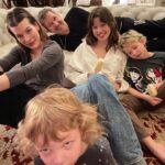 Milla Jovovich Instagram - Happy New Year from the Andersons! This post goes back in time of our epic New Year’s Day. It starts with a hard won family photo where almost everyone is in focus.  Before that I made dinner in our hotel using a one burner hot plate (half the food was pretty lukewarm but still delicious). I made my mom’s famous fried potatoes which is always a hit with the kids, but also some gorgeous asparagus and trumpet mushrooms fresh from the farmers market here in Krakow. I even have my super Eastern European wire rack where I keep the veggies☺️. And of course this morning started with an epic New Years trip to the laundromat which though not very glamorous, was extremely necessary😂. I’m sending so much love to everyone and I hope this New Year brings us all health, love and patience for ourselves and others. Ok, it’s time to put the baby down. Have an amazing night everyone!🍾🎆🎊🎉🎈xo m❤️