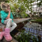 Milla Jovovich Instagram – Never thought a trip to the botanical gardens would make the kids so peaceful and introspective. We all wandered through the humid environment and the little ones would sit so still waiting for the fairies to come out of hiding. The girls watched the reflections of the plants and leaves in the pools of water, speaking in whispers. I took the opportunity to snap some beautiful, poignant pictures that I knew captured the mood we all felt. Some places have magic. You can feel them. Kids feel them even stronger and react in unexpected ways. My own who are usually chatterboxes just perched in out of the way places and let the garden speak to them in its warm, languorous, embracing way. And it all felt exactly as it should. And it all felt just right.  Xo m❤️