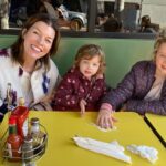 Milla Jovovich Instagram - Happy 3rd Birthday to my amazing littlest one Osian! It’s crazy how she suddenly turned 3 about a month ago. You know the feeling when they’re still toddlers and you can’t really have a conversation with them or reason with them? When they’re just little cave people who are either super happy, super angry, super selfish or super sad with no in between? And then almost overnight they become… little people? And the funny thing is, birthdays don’t really matter, it just happens regardless of when they were born. One day they just “get it”. Well one day about a month ago Osian suddenly began to display this wicked sense of humor. She started being “in on the joke” and with that I realized that my baby had become a full fledged little person who can have conversations and ask a million questions, seeing the world in her own unique, peculiar and truly hilarious way. She is my rainbow baby, my last and final human creation. And just as sweet, loving and spectacular as her two big sisters. We love you so much Osian Lark Elliot Jovovich-Anderson! May your life be as long, interesting and amazing as your name. And when you get married, add another hyphen to it, just because it would be as funny as you are. ❤️🥳🥳🥳 #longestbabynameever #happybirthdayosian