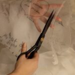 Milla Jovovich Instagram - Today marks the one year anniversary of the war on Ukraine. I am working with exceptional Ukrainian designer @lever_couture who is taking “love letters” for Ukraine and sewing them by hand on a couture gown which will be auctioned off with all proceeds going to @zelenskafoundation.  Here are some pics of the amazing process of making this one of a kind gown! My letter was written as a poem which you can read below:

My motherland cries tears of smoke and ashes
Her men fight with the ingenuity of true belief
So many hearts, so many women torn in pieces
Of husbands, children, cats and curtains, blown out flats
Windows, plates and tea cups, ethics and ideals bombarded by the sounds of missiles landing at the door
The bodies of their men, forced to become hero’s
Whether they wanted to or not 
Their scent, their touch, their familiar voices Whispering words of desperate comfort and of everlasting love
Ripped away, maybe for now, maybe forever
I love you…
Whispered fiercely into a beloved ear
I love you whispered fiercely into the wind 
As the gunfire and the blood drenches Everything and all
I love you Ukraina. 
I love you as my ears explode 
#waronukraine