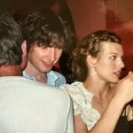 Milla Jovovich Instagram - Me and my husband back when we weee kids ourselves! It’s hard to believe this photo is already 20 years old! My best friend @juliaobst found it at her moms house and sent it to me! It’s incredible to have a partner in my life for so many years. Who’s been with me through so much and still looks at me the way he did when we first met. 🥰 Well, at least most of the time! He gives me funny looks when I try and help my 8 year old with her times tables🤦🏻‍♀️