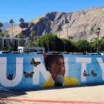Amanda Gorman Instagram - I’ve been thinking a lot about the murals of Black figures I saw in my neighborhood growing up—mostly of dead Black public icons, often slain in their youthful prime, and often men. As I continue to hear from children through my books, the more important I truly believe it is that students of color have representations of our people, not just when they’ve been robbed of life, but also images of us LIVING, of us real and there. The next generation deserves to have artistic mirrors of themselves, young and old, alive as well as resting in power—that is to say, we merit to witness ourselves across the full spectrum of our bright human existence. Because of this, I was so happy I finally got to visit the Unity mural by @misteralek in the Palm Springs art pit! I was pleasantly surprised and incredibly grateful that the City of Palm Springs Arts Fund commissioned such a work. Thank you for this piece of peace, and for everyone who has taken time out of their day to visit 💛💛🙏🏿
