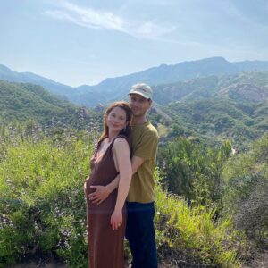 Bonnie Wright Instagram - We’re having a baby! So excited to share this beautiful land with them. What a wild and humbling journey pregnancy is, transforming to make space for new life. Andrew and I can’t wait to meet our baby later this year and become parents 🥹🌈 It feels like they’re coming to say hello in the little rainbow orb across my belly