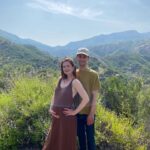 Bonnie Wright Instagram - We’re having a baby! So excited to share this beautiful land with them. What a wild and humbling journey pregnancy is, transforming to make space for new life. Andrew and I can’t wait to meet our baby later this year and become parents 🥹🌈 It feels like they’re coming to say hello in the little rainbow orb across my belly