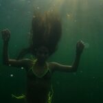 Jessie Reyez Instagram - The amount of peace I feel when I swim out into the middle of a lake is almost inexplicable. Almost. But I’ll try. I think I love it so deeply because a lake is an expression of the unknown, where when I open my eyes, the darkness seems wildly infinite…and yet all the while it reminds my subconscious of the womb we came from. 
I find clemency here. 
I find a sovereignty in water that land has never been able to give me. 
It pardons the gravity of life.
And in that forgiveness 
And in that weightlessness 
I am free. 

📸 @danecollison