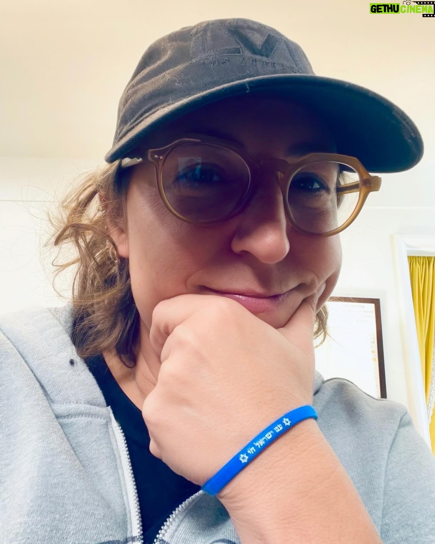 Mayim Bialik Instagram - There are so many fundraisers going on, I know! Here’s me wearing my friend’s “tivkah” band (“band of hope”). http://TikvahBands.com was started by 3 Jewish mothers who could not stand by and do nothing as our brothers and sisters in Israel face the atrocities by those who wish us harm. Tikvah Bands emerged from the Israeli national anthem, the Hatikvah which means hope. Something we can use during this horrific time both in Israel and here in America. When you purchase a Tikvah band, 100% of the profits will be equally distributed to support three organizations that are directly providing vital aid to victims of terror, medical support, trauma recovery, crisis management, and supporting the well-being of Israeli Defense Force soldiers: They are the Jewish Federation, FIDF, and Magen David Adom. If you want to wear your pride and support Israel, this is a great way to do it. 🇮🇱