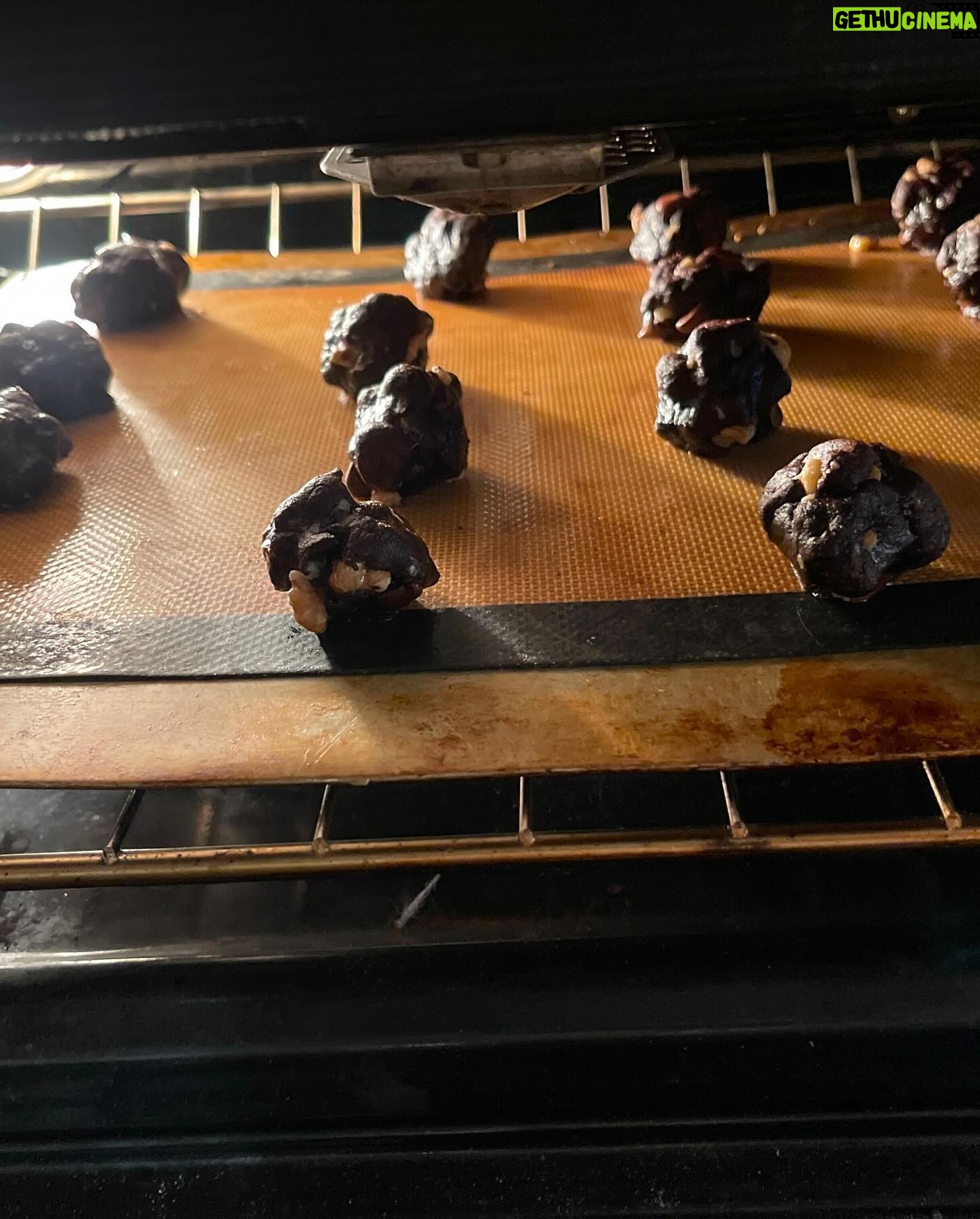 Mayim Bialik Instagram - Couldn’t resist sharing some festive cooking posts. These first 2 photos are broccoli arancini from @Moby’s Little Pine cookbook, which I make with gluten-free Panko.
Next up are my veganized “Darrell’s ‘Forget-the-Cookies-Just-Give-Me-That-Batter’ Chocolate Chip Cookies” that I was in the process of making during yesterday’s Live with @jonathancohenofficial (head over to @bialikbreakdown if you missed it!). Shout out to my 1987 edition of KidsCooking: A Very Slightly Messy Manual from Klutz press (a pretty cool company) for the recipe.
INGREDIENTS:
- 1/2 cup vegan butter
- 1/2 cup brown sugar
- 1/2 cup white sugar (yes, it’s a lot of sugar, but that’s why I only make them for the holidays 😬)
- 1 tsp vanilla extract
- 1 vegan egg replacement (I use Bob’s Mill egg replacer)
- 1 1/8 cups flour (If I’m feeling frisky, I replace 3/4 cup of the flour with cocoa. That’s what I did with this recipe. 🤫
- 1/4 tsp salt
- 1/2 tsp baking soda
- 1 bag (6 oz) vegan chocolate chips
- 1/2 cup walnuts - optional (sometimes I make them with pecans but this time I did it with walnuts)
INSTRUCTIONS:
1. In a small pan, melt the butter. While it’s hot, add both sugars. Stir, then let cool a bit.
2. While the butter mixture is cooling, mix the flour, baking soda, and salt in a mixing bowl.
3. In a separate small bowl, stir the egg replacer in with the vanilla and butter mixture.
4. Add the butter, egg replacer, and vanilla to the flour mixture in the mixing bowl. Stir again, then add chocolate chips and nuts if you want them.
5. Stir everything until it’s all mixed up well and put the bowl in the refrigerator to cool for about an hour.
6. Preheat the oven to 375 degrees F.
7. Roll the dough into walnut-sized balls, put them onto an ungreased baking sheet, and bake for 10 min. Allow to cool, and enjoy!