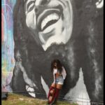 Jessie Reyez Instagram - “Is this love” cover, out now. When I was presented with the opportunity to cover such a legendary song for such a legendary movie, I almost said no. Considering how much I’ve always looked up to Bob, it seemed almost sacrilegious to attempt a song that i find so holy. “Is this Love”. A beautiful message from an artist who has provided medicine in the form of music to the world; a world that feels like it needs double the dose right now. Like most of us, there have moments in my life where burdens of the human experience have been heavier than I could bear. One moment in particular, I had landed in Toronto, circumstances rendered my tears to be waves and I couldn’t come up for air. I had to do a gig that night and I was trying to find grounding. I remember laying on a bench near the airport downtown and looking up at a canopy of trees above me. Bob came on and I felt instantly soothed. My tears dried. I decided to say yes to singing this because I chose to view it as an opportunity to pay homage to the sacred. To all involved, thank you for inviting me to be a part of this @ziggymarley @onelovemovie 

The last photo was taken years ago by @demarp when i used to be a bartender in Florida. Back when the idea of being a full time musician was as just a dream. The respect and love I’ve had for Bob goes very far back. Jamaica, the world owes you one.🇯🇲❤️