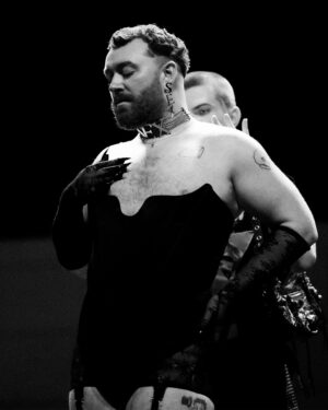 Vivienne Westwood Instagram - BEHIND THE SCENES: Echoing the ‘Blackout’ theme, @samsmith ‘s bespoke Vivienne Westwood show looks are presented in shades and textures of black.⁠
⁠
For the opening look, Sam appears in a double-breasted cropped jacket with braided epaulettes and aiguillettes worn with sailor trousers.⁠
⁠
Later in the show Sam reveals a corseted bodice paired with our iconic SEX choker and spiral lace gloves with claws.