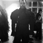Vivienne Westwood Instagram – BEHIND THE SCENES: Echoing the ‘Blackout’ theme, @samsmith ‘s bespoke Vivienne Westwood show looks are presented in shades and textures of black.⁠
⁠
For the opening look, Sam appears in a double-breasted cropped jacket with braided epaulettes and aiguillettes worn with sailor trousers.⁠
⁠
Later in the show Sam reveals a corseted bodice paired with our iconic SEX choker and spiral lace gloves with claws.