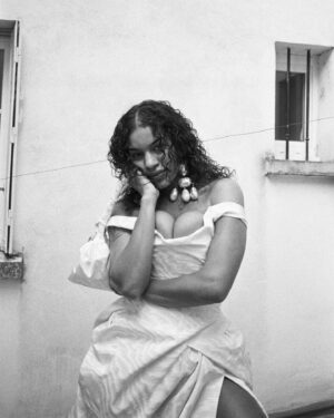 Vivienne Westwood Instagram - "We live in a world now, where we are allowed to have a slightly different outlook on life than in the past" –  Briana.⁠
⁠
Briana's reimagined look for 2024 is offered in a silk Moire fabric, with a shimmering finish. The voluminous asymmetric skirt features drape details, complete with a train at the back. The piece is offered alongside a matching fabric handmade bag, as originally crafted by Briana herself. ⁠
⁠
Photography by @kingsley_ifill⁠
Styling by @florahuddart⁠
Talent: @briannatoomer⁠
⁠
#VWBridal #WestwoodBridal