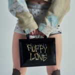 Vivienne Westwood Instagram – Our oversized Cropped Denim Boxer jacket features this season’s floral jacquard, inspired by an archival corset from our Spring-Summer 1998 ‘Tied To The Mast’ collection. ⁠
⁠
Style the piece with our Tyra Toy Box bag, featuring a bone motif that links together with rivets, forming the words ‘Puppy Love’. The style is reminiscent of our Rock chicken bone T-shirt, from the archive ‘Let It Rock’ collection of 1971.⁠
⁠
Now available online and across our boutiques.⁠
⁠
#VWSS24