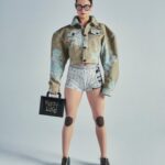 Vivienne Westwood Instagram – Our oversized Cropped Denim Boxer jacket features this season’s floral jacquard, inspired by an archival corset from our Spring-Summer 1998 ‘Tied To The Mast’ collection. ⁠
⁠
Style the piece with our Tyra Toy Box bag, featuring a bone motif that links together with rivets, forming the words ‘Puppy Love’. The style is reminiscent of our Rock chicken bone T-shirt, from the archive ‘Let It Rock’ collection of 1971.⁠
⁠
Now available online and across our boutiques.⁠
⁠
#VWSS24