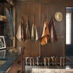 Ree Drummond Instagram – Here’s Ladd’s mud room and here’s what’s in it: coats, jackets, boots, spurs, work gloves, hats, Carmex, tools, sink, ice maker (for coolers), pop fridge (for Dr Pepper), bathroom (I don’t go in there), washer/dryer (never had separate ones before now and I embrace it), and an old pic of him and his brothers in their old barn. Oh, and mud. (And he still looks good in chaps, btw…)