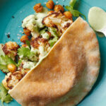 Martha Stewart Instagram - Eating more plant-based meals just got easier, and even healthier. Cauliflower and chickpeas are seasoned with cumin and roasted until golden brown. Then they're stuffed into pitas with a zesty sauce made from cilantro, lime juice, and jalapeño peppers. Get the recipe at the link in our bio. 📷: @chrisrsimpson