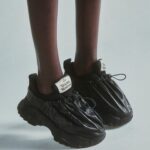 Vivienne Westwood Instagram - Find new and renewed silhouettes across luxury garments and accessories. Styles feature our archive Chain handbag, revisited with bondage-inspired hoops and a towelling fabric, or our Romper Bag trainers, offered in a black colourway this season.⁠
⁠
Now available online and across our boutiques. ⁠
⁠
#VWSS24