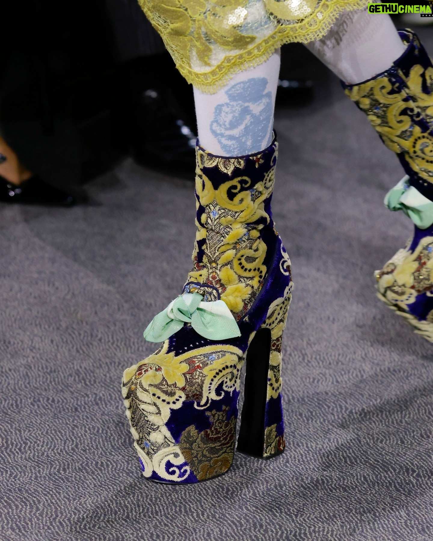 Vivienne Westwood Instagram - 'She had a very special relationship to time, she truly travelled in her mind' – Andreas on Vivienne.
Look #18 from the Andreas Kronthaler for Vivienne Westwood Spring-Summer 2024 collection, featuring elevated platforms, styled alongside a small show tote bag, and the Calypso Dress in sequin cotton lace.
#AKVWSS24