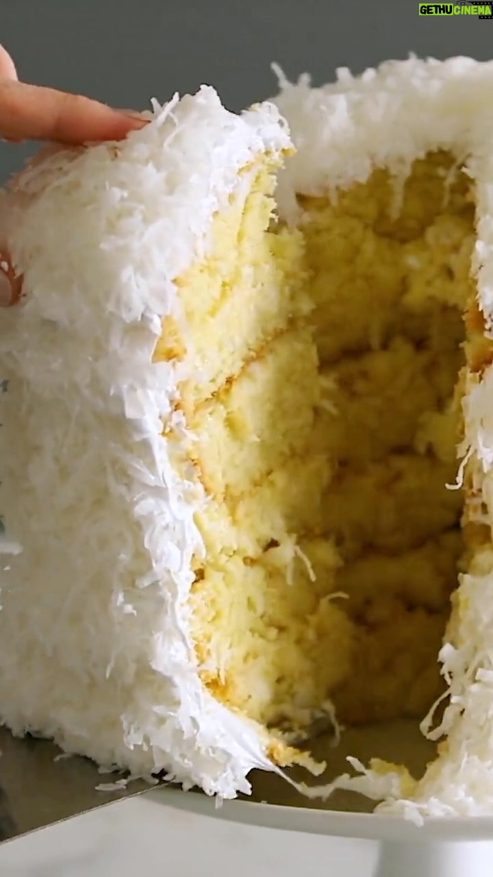 Martha Stewart Instagram - This cake is a coconut lover’s dream. It’s a towering creation of six tender cake layers sprinkled with shredded coconut and filled with a rich coconut custard. Frosted with mountains of billowy seven-minute frosting, it becomes even taller. Make it for a special occasion—there’s nothing better for a coconut fan than this showstopping confection. Get the recipe at the link in our bio.