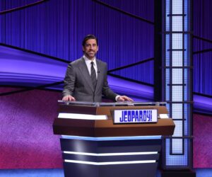 Aaron Rodgers Instagram - This is the @jeopardy podium, and my sticky notes from the 2nd day of filming. I used a lot of these stickies over the couple days of filming and put reminders on there like “Speak Less”, which was an ode to Paul Rudd on Forgetting Sarah Marshall, during surf lessons; “do less”. “Slow Down”, a reminder for me when reading the clues 💯. “Stand Up Straight”; every time I’m reading clues I’m bent over, so that was a reminder to stand up in certain moments when I knew I was on camera. 
“Relax” and “Energy” were just a couple other good reminders as well.  And the last one, was just to check if anyone was looking at my podium between games. Turns out, John the stage manager was, and we had a good laugh about it 😂😂😂 #lovethisshowsomuch #somuchgratitude #last3days #