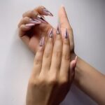 Aastha Gill Instagram – Previously we did ombre nails that became everyone’s first choice! This time she’s going for a launch where she’s wearing all black, so she wanted to go for nude base with some black n bling. #nailsbyaryan #aasthagill #agog #sunnyhairport