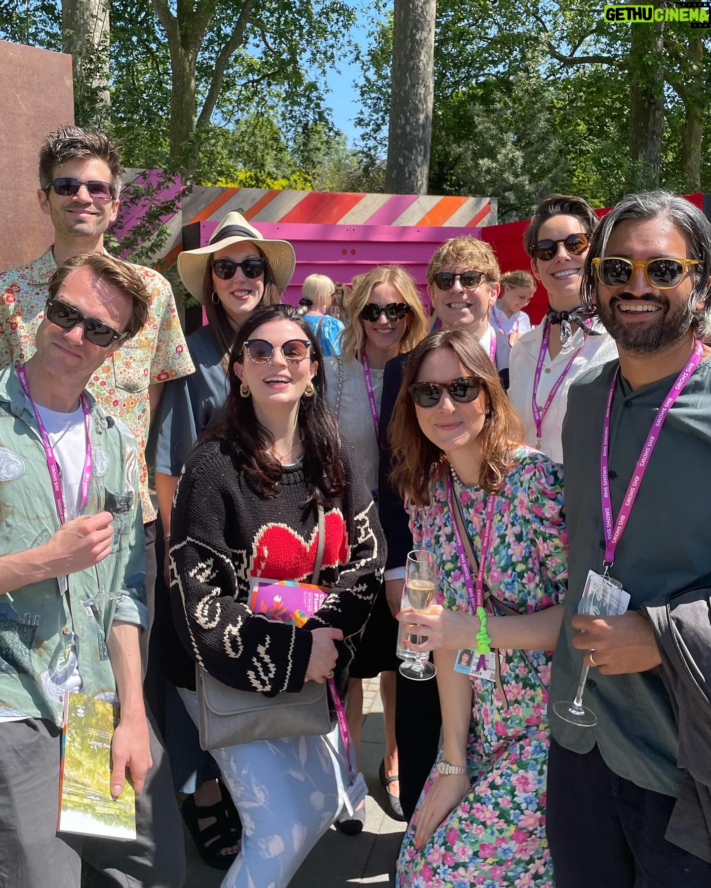 Aisling Bea Instagram - Avoided drawing attention to myself today @the_rhs Chelsea Flower show, if you zoom in, you will be able to make me out. I LOVE power plants & BIG bushes & there were so many on display today. But my favourite garden was my friend @tommasseyuk ‘s one for @wateraid which he co-designed with Je @studioweave - both seen here with @josh_widdicombe who did not get the “dress like a flower”memo. The garden features flowers and plants which are resilient to extremes in weather, especially rainfall, which is more important than ever with our changing climate. Also some flowers which may be not deemed as fancy and pretty as others, which breaks my hear as they are ALL loveable. Almost one in ten people around the world don’t have access to clean water close to home, and the climate crisis is making it worse. So the mushroom like design is a rainwater-harvesting pavilion inspired by WaterAid’s work in communities around the world. “But tell us about your outfit so we too can completely cover up in the sun!” Well, I tried to wear an eco outfit today featuring a gorgeous but ill advised in the sun jumper from small brand @theslowlove , a flowery dress from @reformation who make their clothes from leftover material, jewellery & a handbag which fits everything from a variety of charity shops & some earth day shoes from eco brand @vivaia_official who make their shoes from recycled materials and try to reduce waste in their factories. Bought everything so you can TRUST ME. Thanks to @thenewtinsomerset & @the_ivy_collection for feeding myself, my brother in law @mkidao & auntie in law - we are stuffed and covered in pollen. And thank you to @lordham for making sure my hair was nice and shiny. xxx