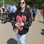 Aisling Bea Instagram - Avoided drawing attention to myself today @the_rhs Chelsea Flower show, if you zoom in, you will be able to make me out. I LOVE power plants & BIG bushes & there were so many on display today. But my favourite garden was my friend @tommasseyuk ‘s one for @wateraid which he co-designed with Je @studioweave - both seen here with @josh_widdicombe who did not get the “dress like a flower”memo. The garden features flowers and plants which are resilient to extremes in weather, especially rainfall, which is more important than ever with our changing climate. Also some flowers which may be not deemed as fancy and pretty as others, which breaks my hear as they are ALL loveable. Almost one in ten people around the world don’t have access to clean water close to home, and the climate crisis is making it worse. So the mushroom like design is a rainwater-harvesting pavilion inspired by WaterAid’s work in communities around the world. “But tell us about your outfit so we too can completely cover up in the sun!” Well, I tried to wear an eco outfit today featuring a gorgeous but ill advised in the sun jumper from small brand @theslowlove , a flowery dress from @reformation who make their clothes from leftover material, jewellery & a handbag which fits everything from a variety of charity shops & some earth day shoes from eco brand @vivaia_official who make their shoes from recycled materials and try to reduce waste in their factories. Bought everything so you can TRUST ME. Thanks to @thenewtinsomerset & @the_ivy_collection for feeding myself, my brother in law @mkidao & auntie in law - we are stuffed and covered in pollen. And thank you to @lordham for making sure my hair was nice and shiny. xxx