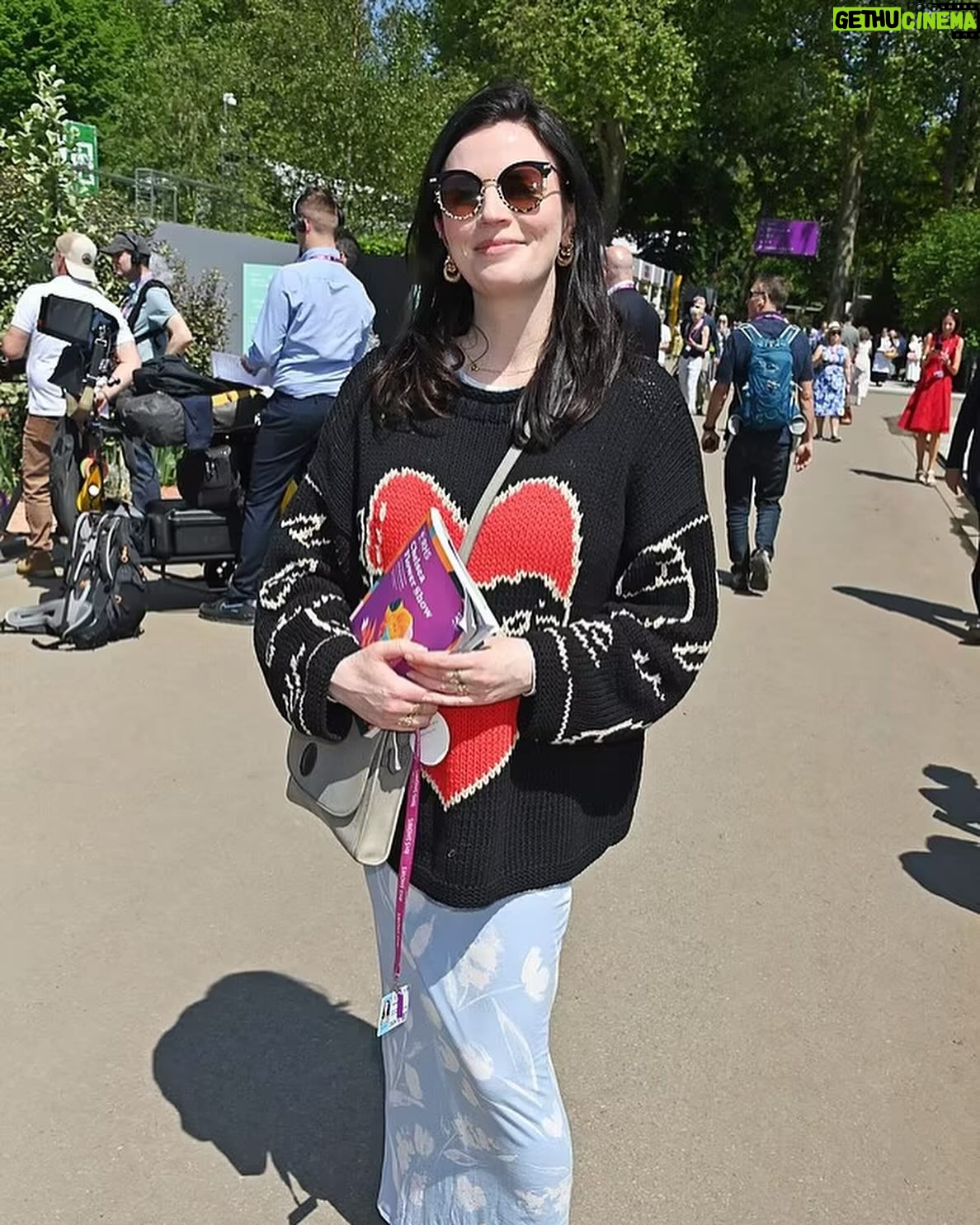 Aisling Bea Instagram - Avoided drawing attention to myself today @the_rhs Chelsea Flower show, if you zoom in, you will be able to make me out. I LOVE power plants & BIG bushes & there were so many on display today. But my favourite garden was my friend @tommasseyuk ‘s one for @wateraid which he co-designed with Je @studioweave - both seen here with @josh_widdicombe who did not get the “dress like a flower”memo. The garden features flowers and plants which are resilient to extremes in weather, especially rainfall, which is more important than ever with our changing climate. Also some flowers which may be not deemed as fancy and pretty as others, which breaks my hear as they are ALL loveable. Almost one in ten people around the world don’t have access to clean water close to home, and the climate crisis is making it worse. So the mushroom like design is a rainwater-harvesting pavilion inspired by WaterAid’s work in communities around the world. “But tell us about your outfit so we too can completely cover up in the sun!” Well, I tried to wear an eco outfit today featuring a gorgeous but ill advised in the sun jumper from small brand @theslowlove , a flowery dress from @reformation who make their clothes from leftover material, jewellery & a handbag which fits everything from a variety of charity shops & some earth day shoes from eco brand @vivaia_official who make their shoes from recycled materials and try to reduce waste in their factories. Bought everything so you can TRUST ME. Thanks to @thenewtinsomerset & @the_ivy_collection for feeding myself, my brother in law @mkidao & auntie in law - we are stuffed and covered in pollen. And thank you to @lordham for making sure my hair was nice and shiny. xxx