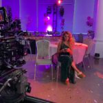 Alexa PenaVega Instagram – Last day with this very special group of people. The last photo (while hilarious) is actually something we have never seen on a set before. We were filming a “summer” day while there was literal snow falling… everyone on camera (the amazing background actors, me and Los) were freezing wearing summer clothing doing our best to fake being warm. Our amazing and beyond wonderful director Felipe decided if we had to suffer… he would suffer with us. 😭🙌🏽 This man had his shirt off until we finished the scene. 🙈 Never in my thirty years of show biz have I experienced a director do this🤣. We love you Felipe! Thank you for an incredible shoot!